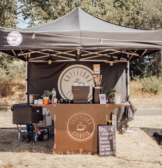 The folding gazebo serves as a mobile bar. Delicious coffee is sold underneath.