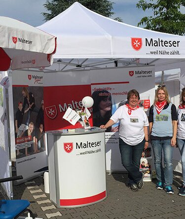 Gazebo bianco 3x3m personalizzato con logo Malteser e telo laterale utilizzato per esposizione